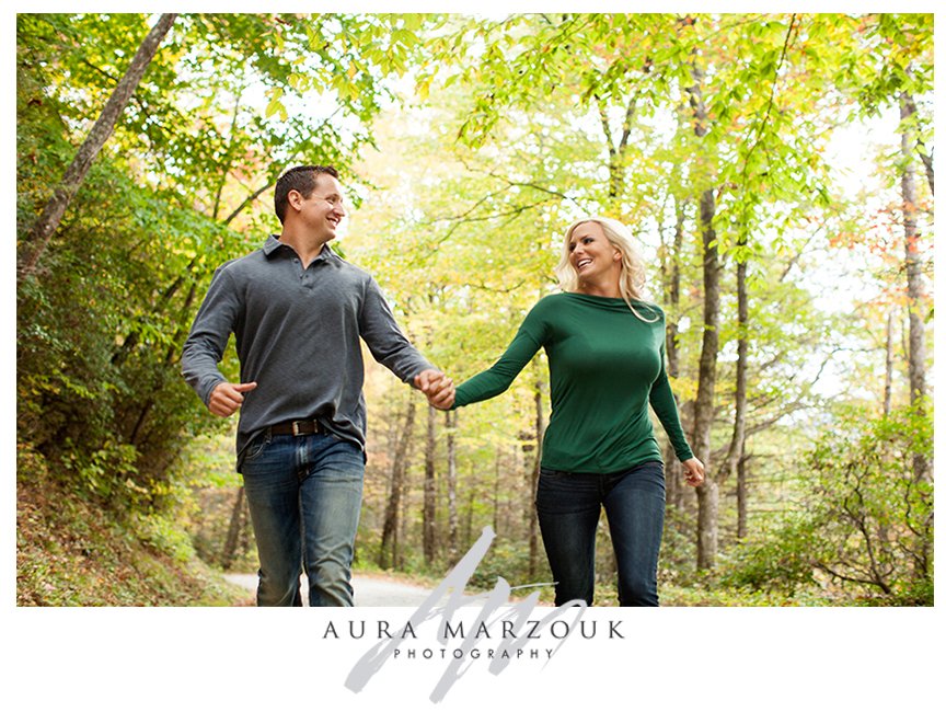 Future bride and groom run through the mountains at their Pisgah National Forest engagement session. © Aura Marzouk Photography, Greensboro Wedding Photographer