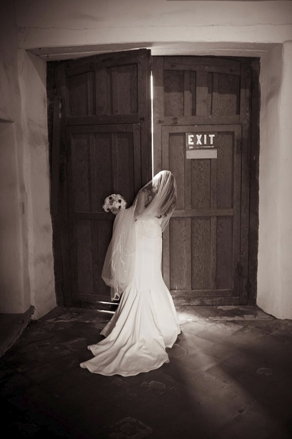 Carmel Mission bride in long train wedding dress