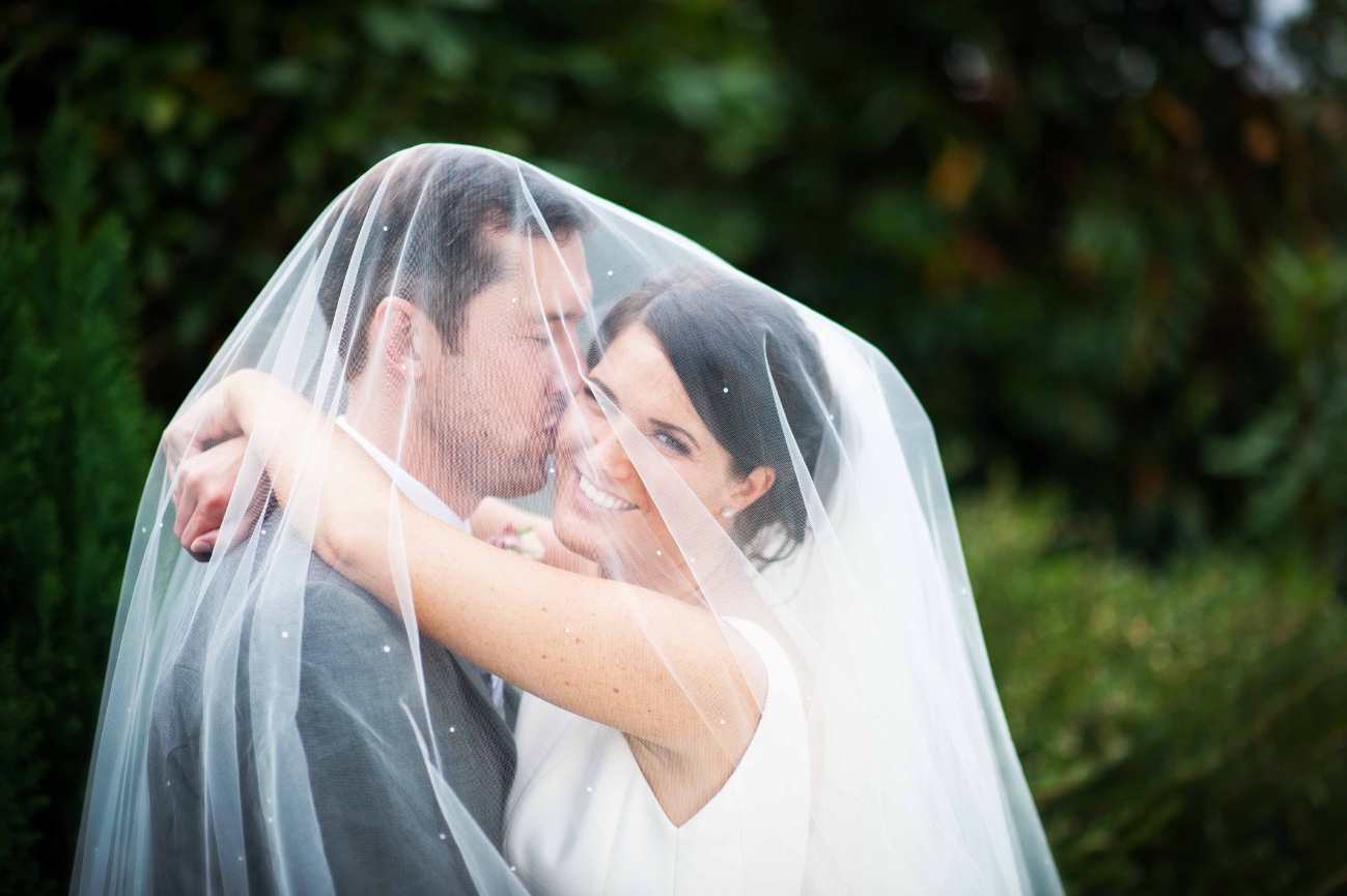 romantic bride and groom shot under the veil