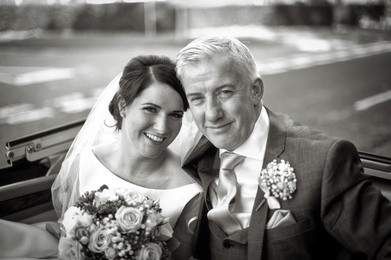 Bride and father in car arriving at church