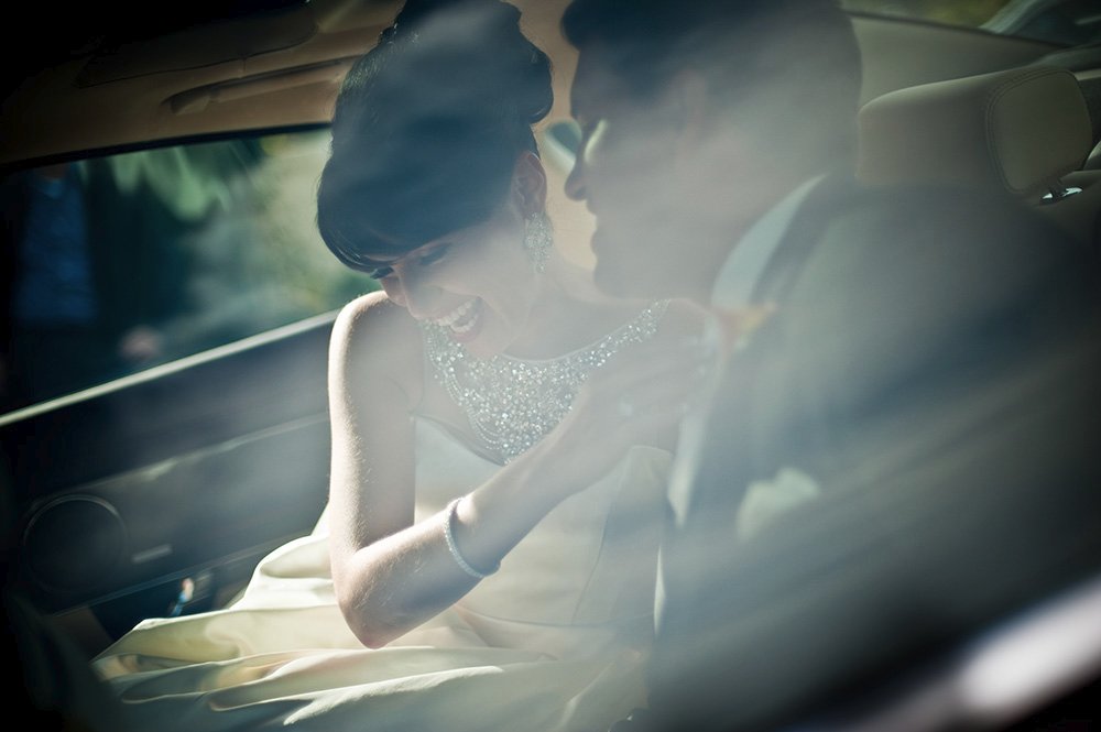 Bride and groom leaving Spanish wedding in new Jaguar