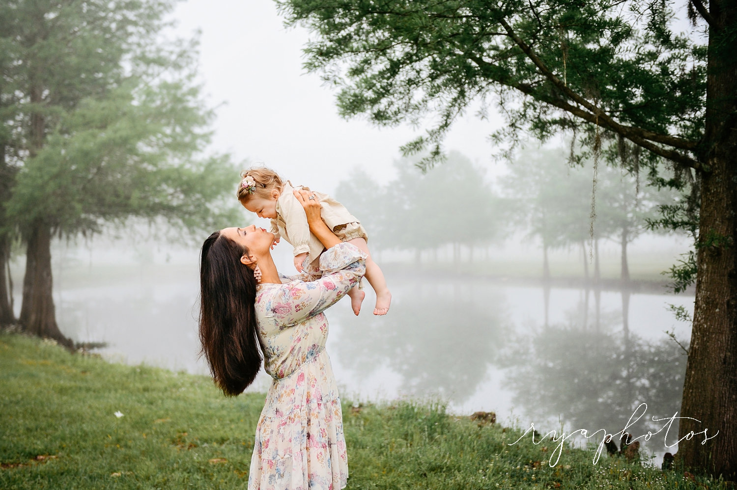 mother lifting up baby daughter, best Jacksonville motherhood photographer, Rya Duncklee