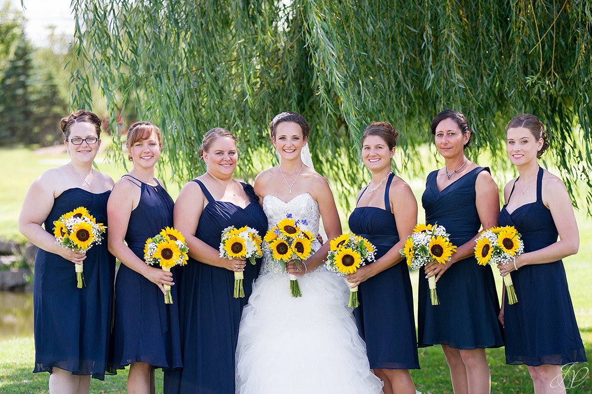 bridesmaids in dark blue with sunflowers