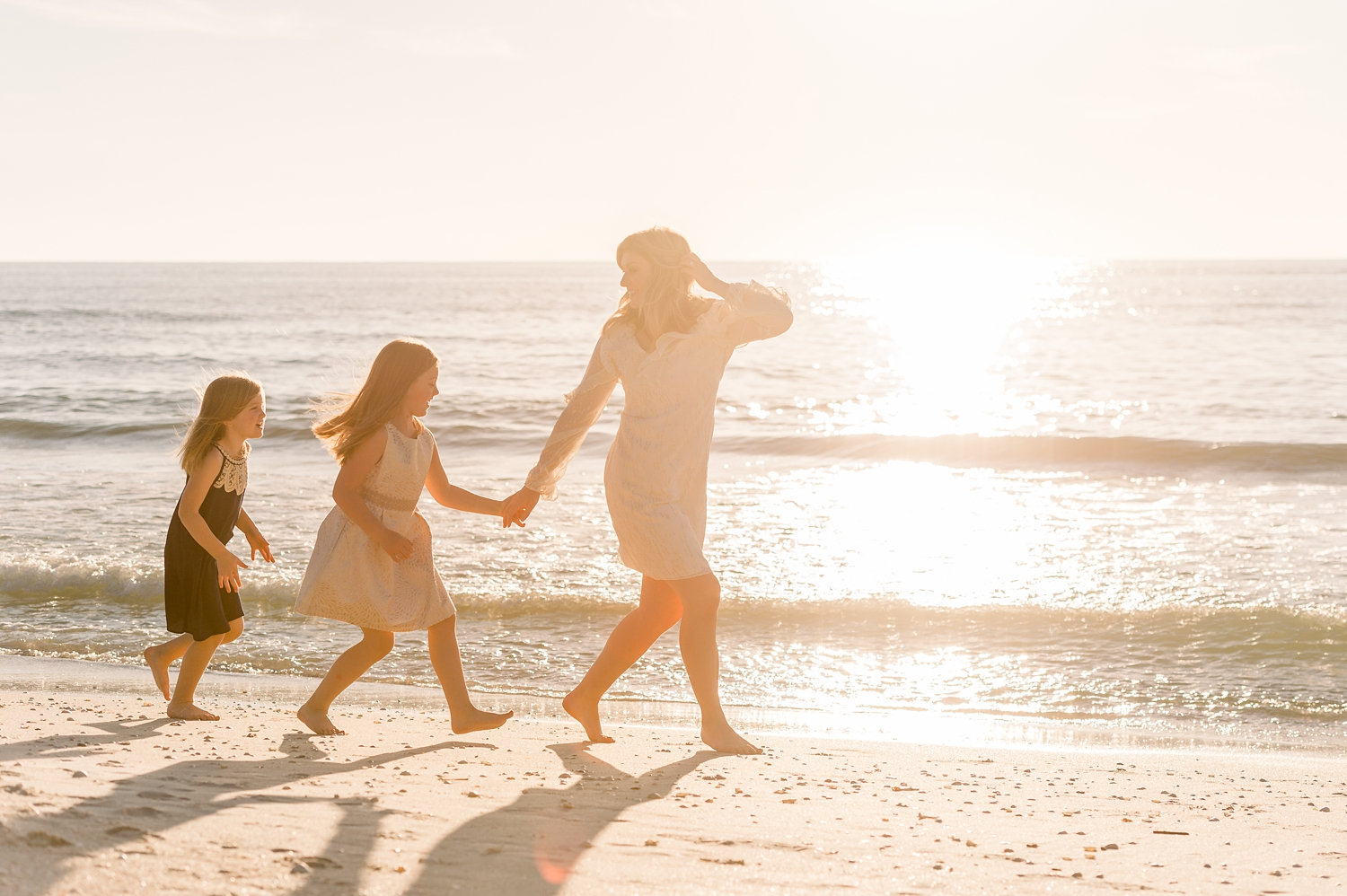 mom and daughters walking along beach, Naples, Florida, Rya Duncklee