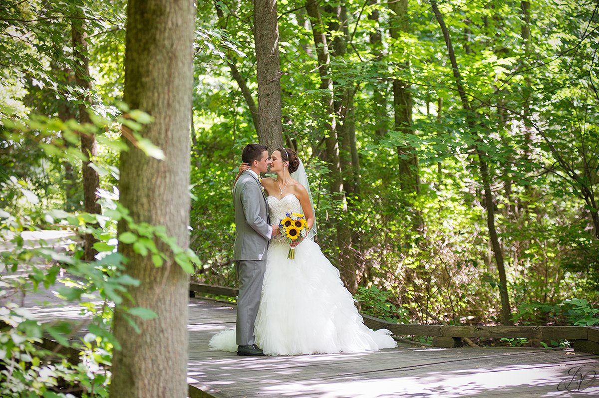 bride and groom on bridge walkway Timberlodge at Arrowhead Golf Club