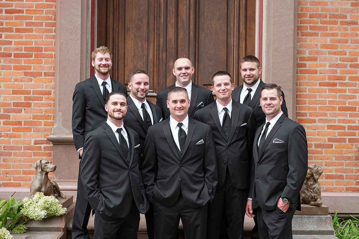 groomsmen outside of brick building canfield casino