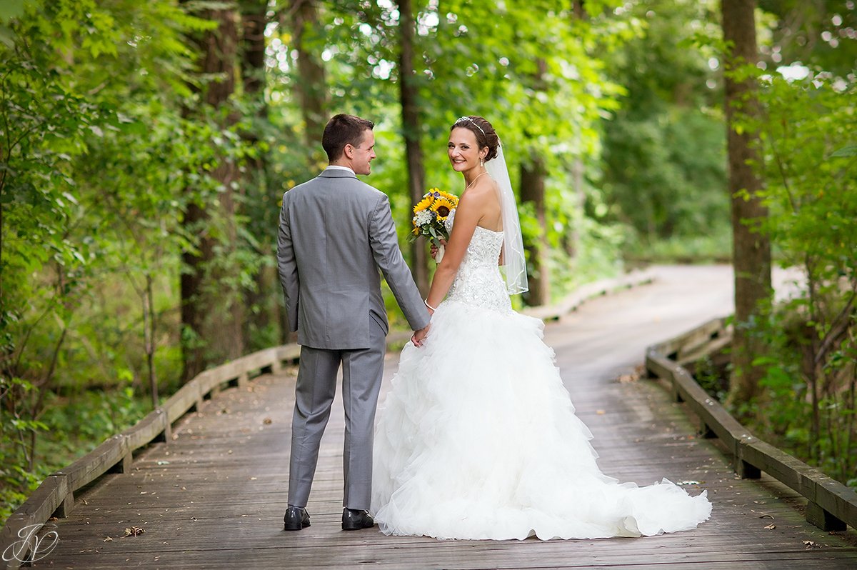 bride and groom on bridge walkway Timberlodge at Arrowhead Golf Club