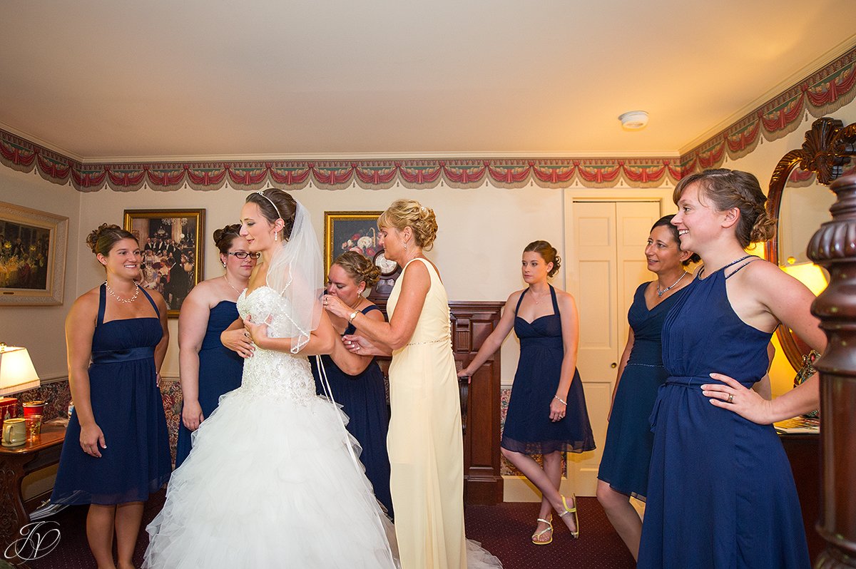 bride getting ready with mom and bridesmaids