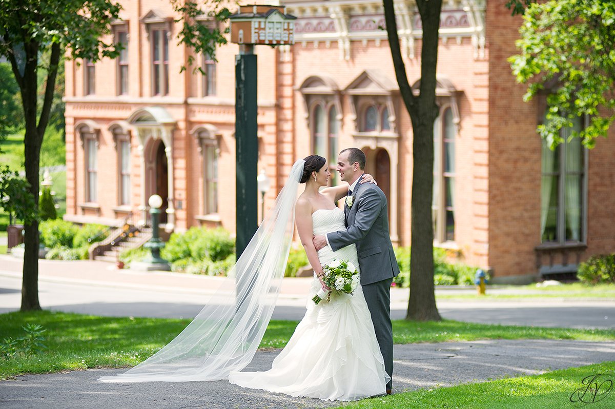 bride and groom photo in congress park with view of canfield casino saratoga springs