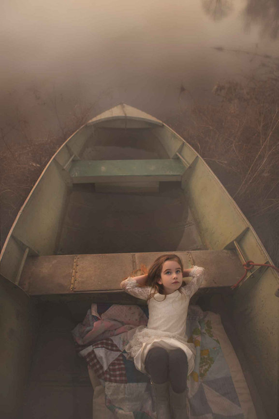 Fort Worth senior portrait in canoe on misty water, styled as a dreamy fine art session.