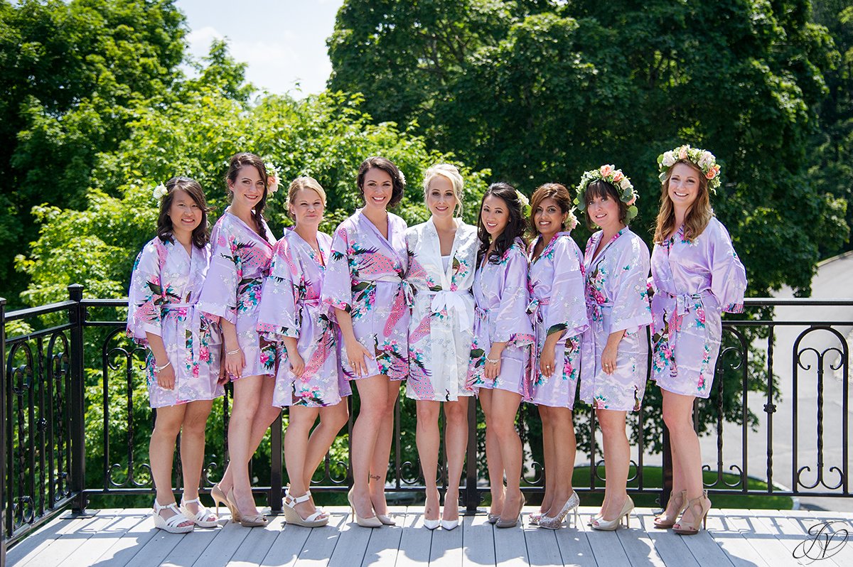 bride and bridesmaids in matching robes on terrace