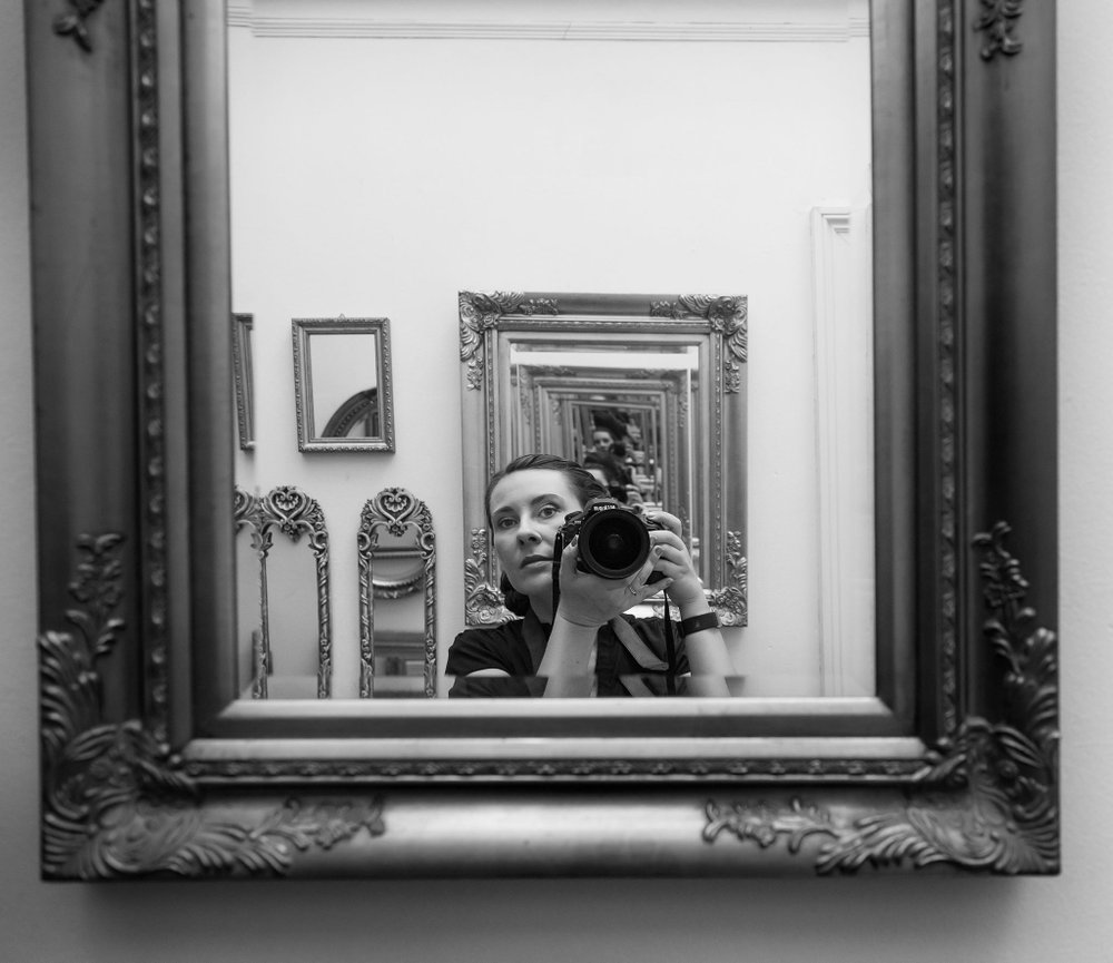 mirror reflection of Irene Jones of IJ Photo with her nikon camera