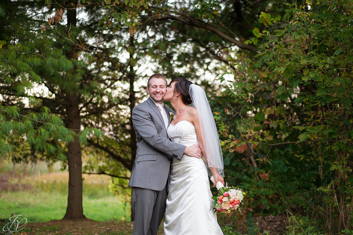 cute photo of bride kissing groom on the cheek