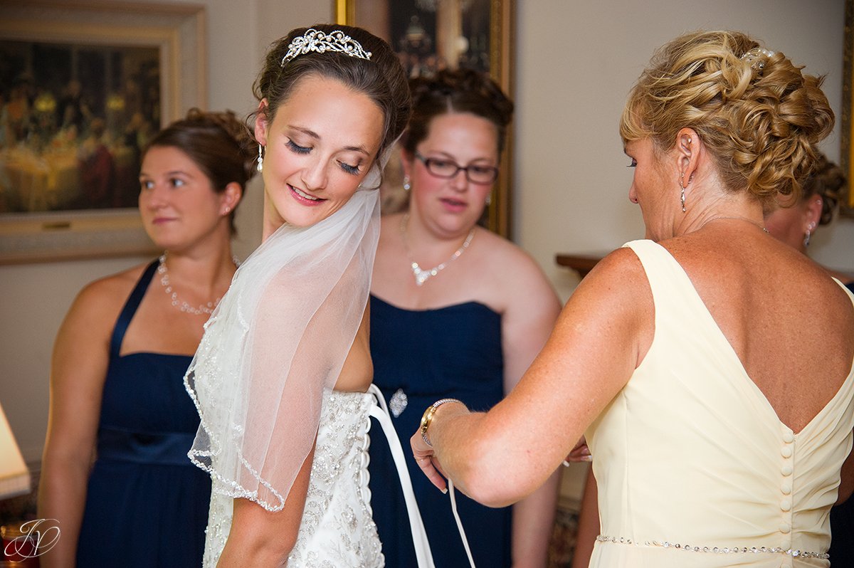 bride getting ready with mom and bridesmaids