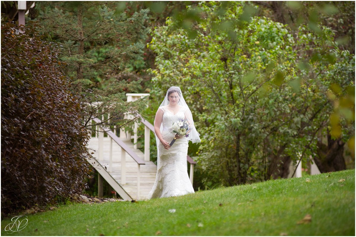 bride walks down the aisle alone flowing veil