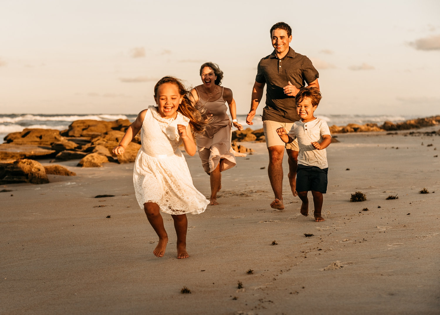 family of four running on Saint Augustine Beach, Florida, Rya Duncklee Photos