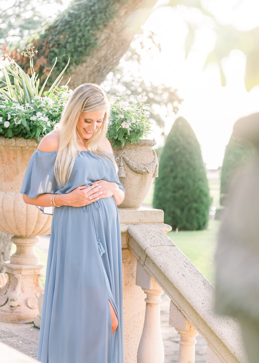 maternity photo, pregnant blonde woman with long blonde hair, wearing delicate jewelry and a strapless blue dress, Jacksonville, Florida