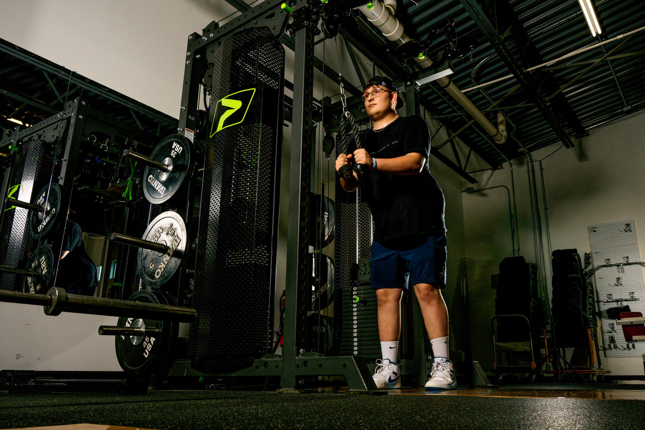 senior boy working out during his senior pictures at Coolspring Fitness in Mercer PA