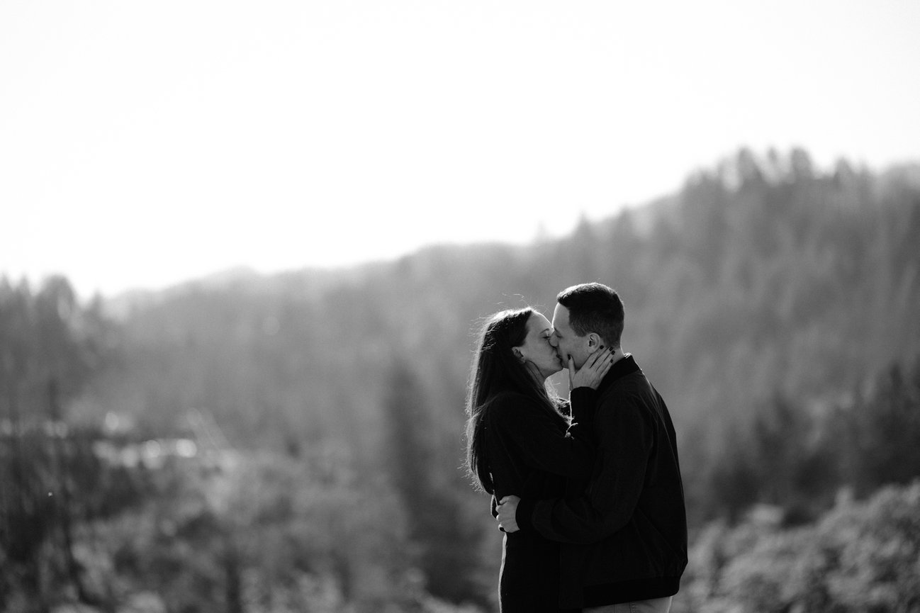 Man and woman kissing after their proposal at Pride Mountain Vineyards in St Helena Ca, photographed by Studio J Portraits
