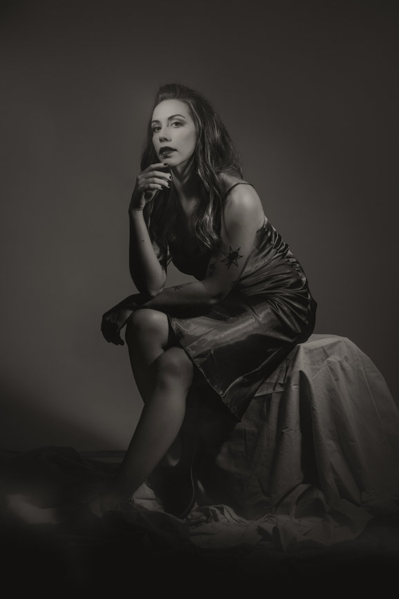 Old hollywood styled black and white portrait of woman in elegant dress and makeup, taken in a photo studio with Adam Trujillo, a Las Vegas portrait photographer.
