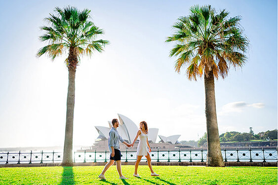 Couple walking in a park during a Sydney Opera House Photoshoot with Sarah Iris Photography.