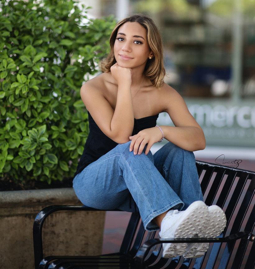 Senior on outdoor mall bench, urban fine art editorial portrait by Swartz Portraits Houston metro Texas
