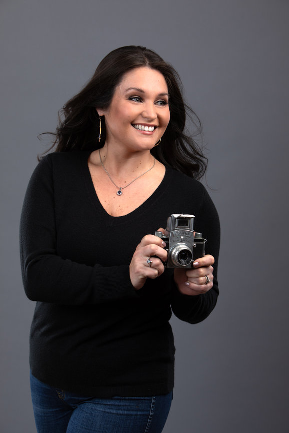 cheerful breezy branding portrait of happy woman with vintage camera