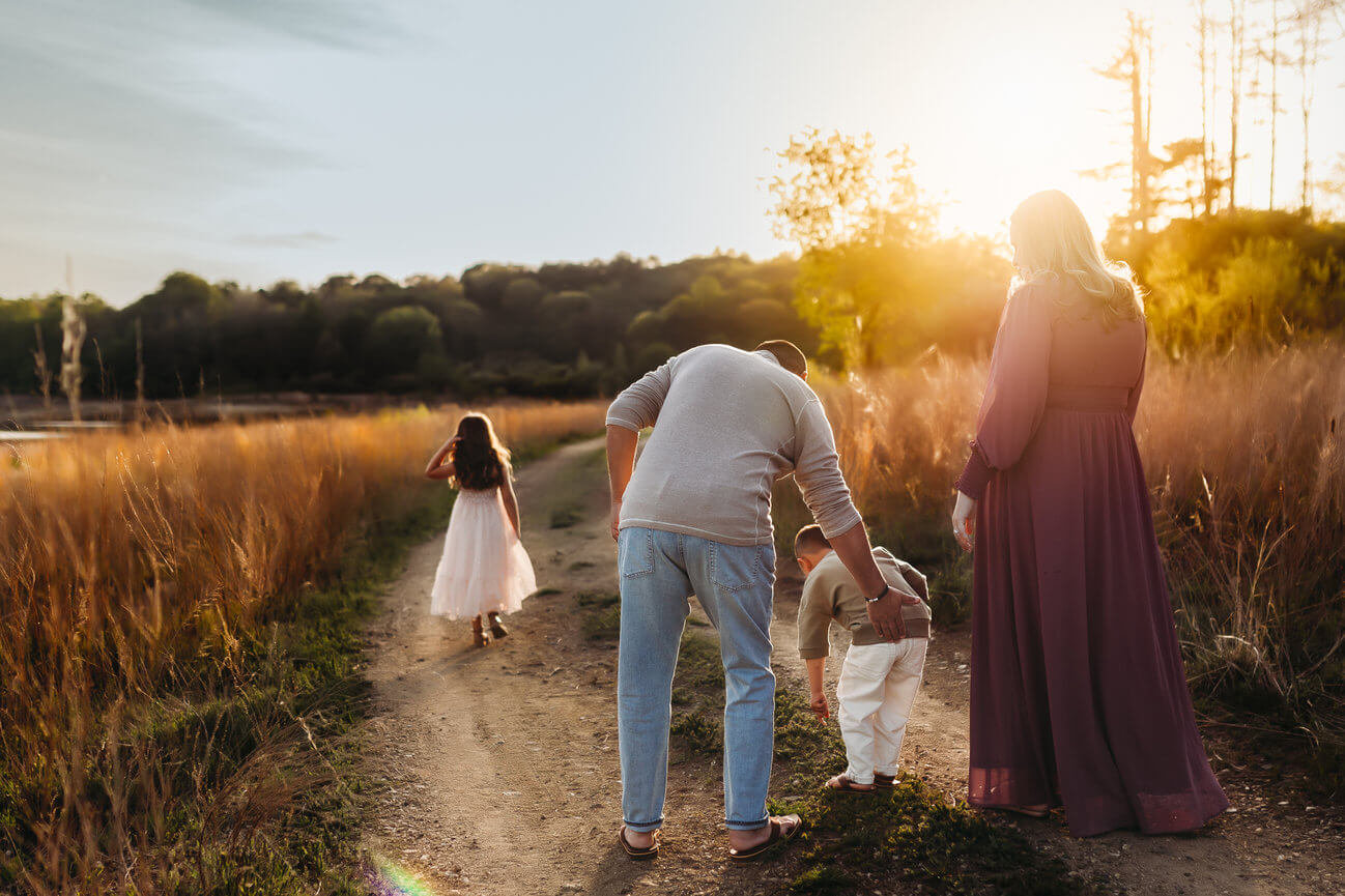 A family walking down a path during their family photo session in Hunterdon County, New Jersey.