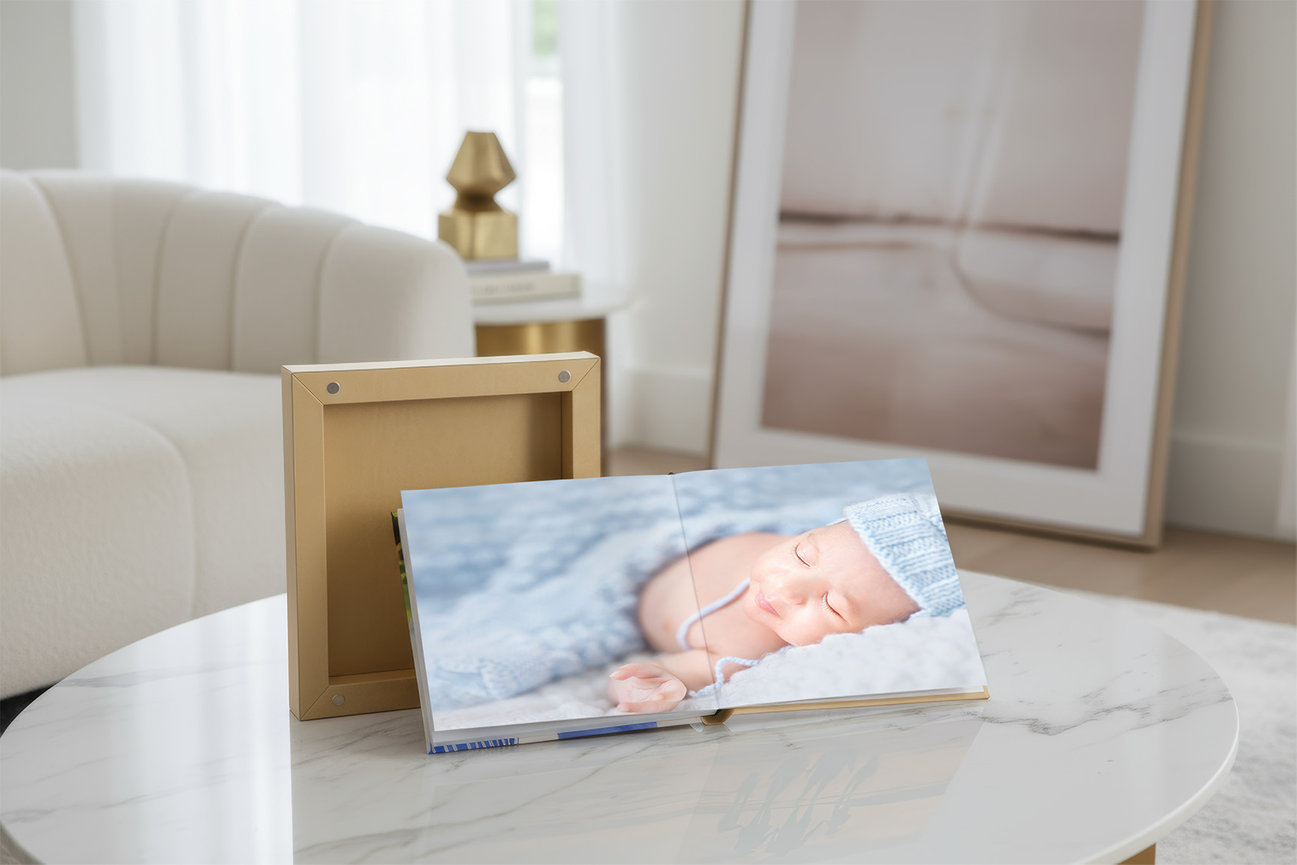 Handcrafted album with baby and family portraits, presented as a refined and lasting collection of images