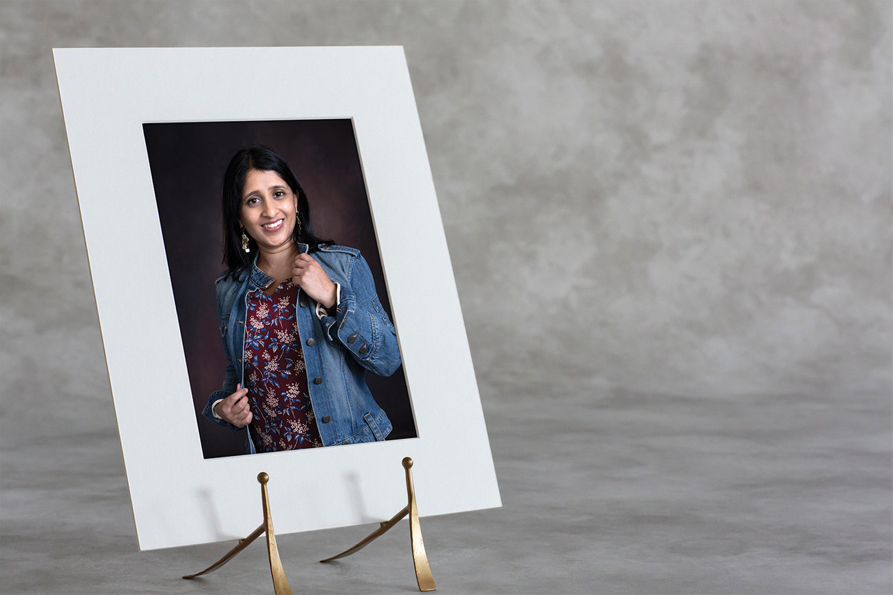 matted portrait print displayed on an easel within a clean, refined home setting