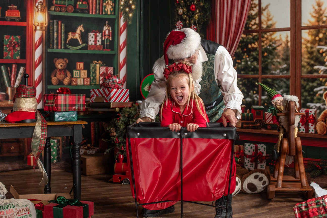 A child and Santa working at the festive gift-wrapping conveyor