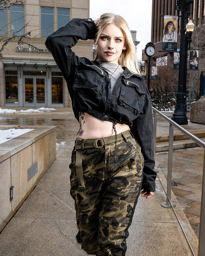 Model wearing a cropped black jacket and camo pants from Fashion Nova, posing confidently at City Creek Center in Salt Lake City, Utah. Captured by Tre Nelson Photo for a Fashion Nova spec shoot.