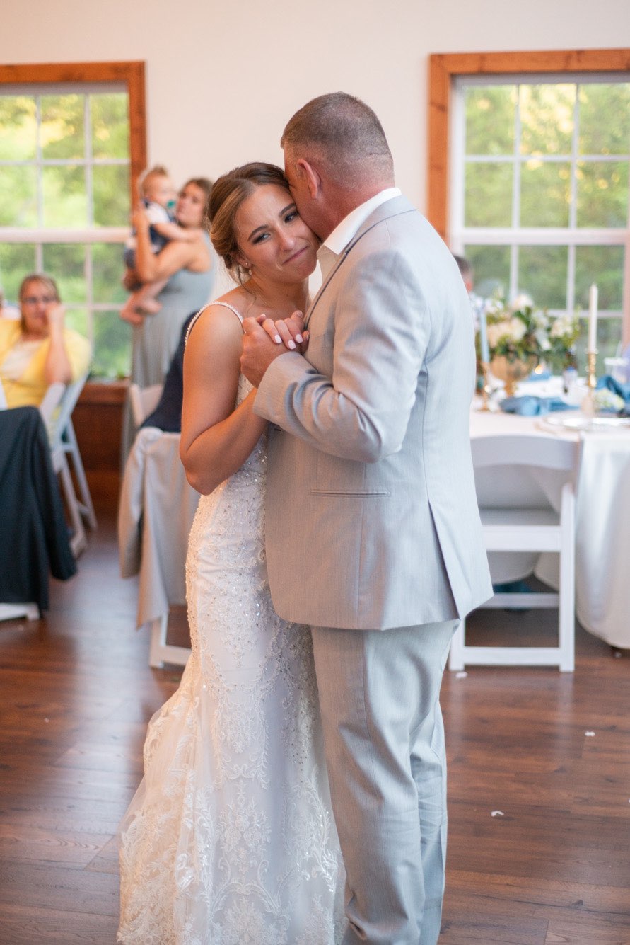 Father dancing with his daughter at a wedding reception near Branson, Missouri.