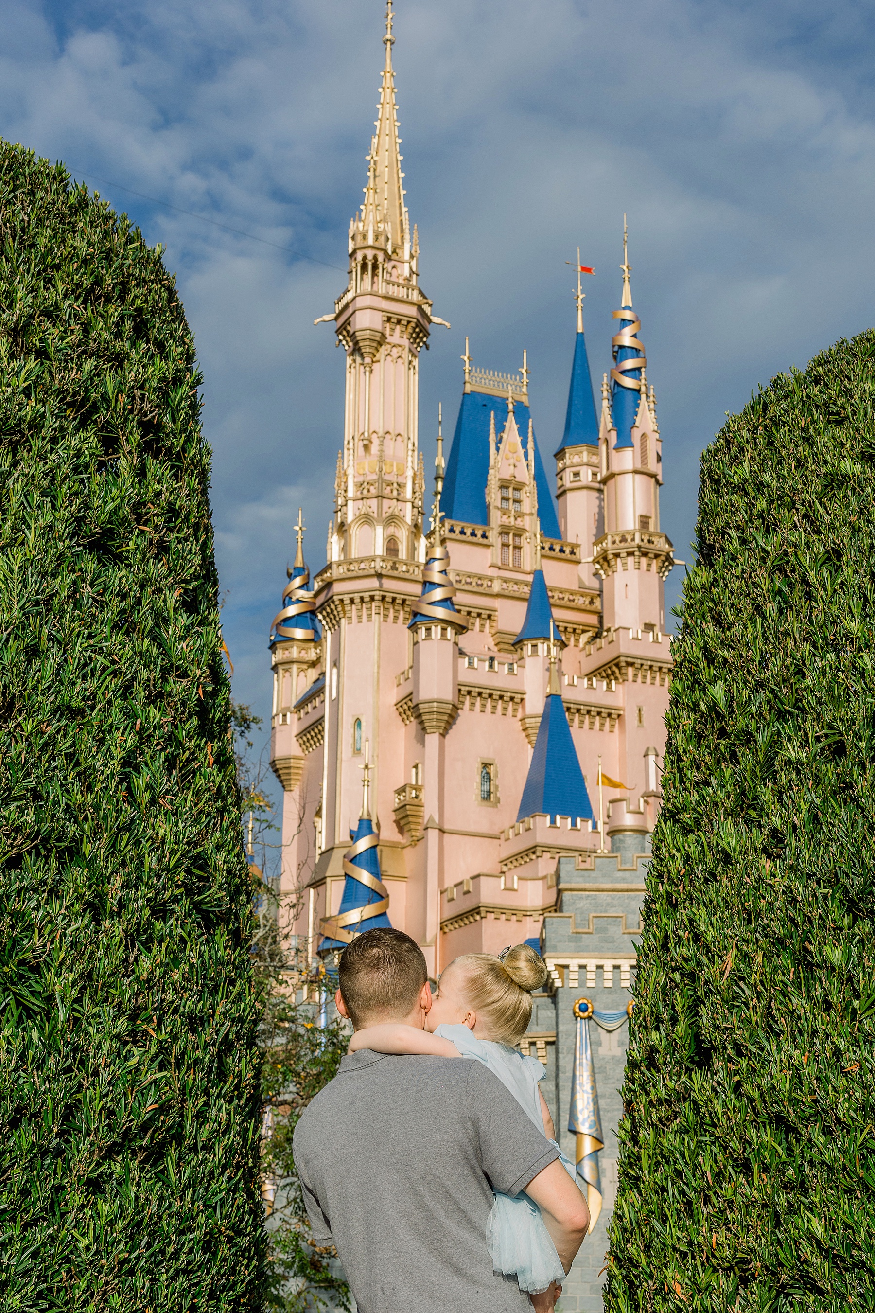 man with his daughter looking up at Cinderella's Castle at Walt Disney World Orlando Florida