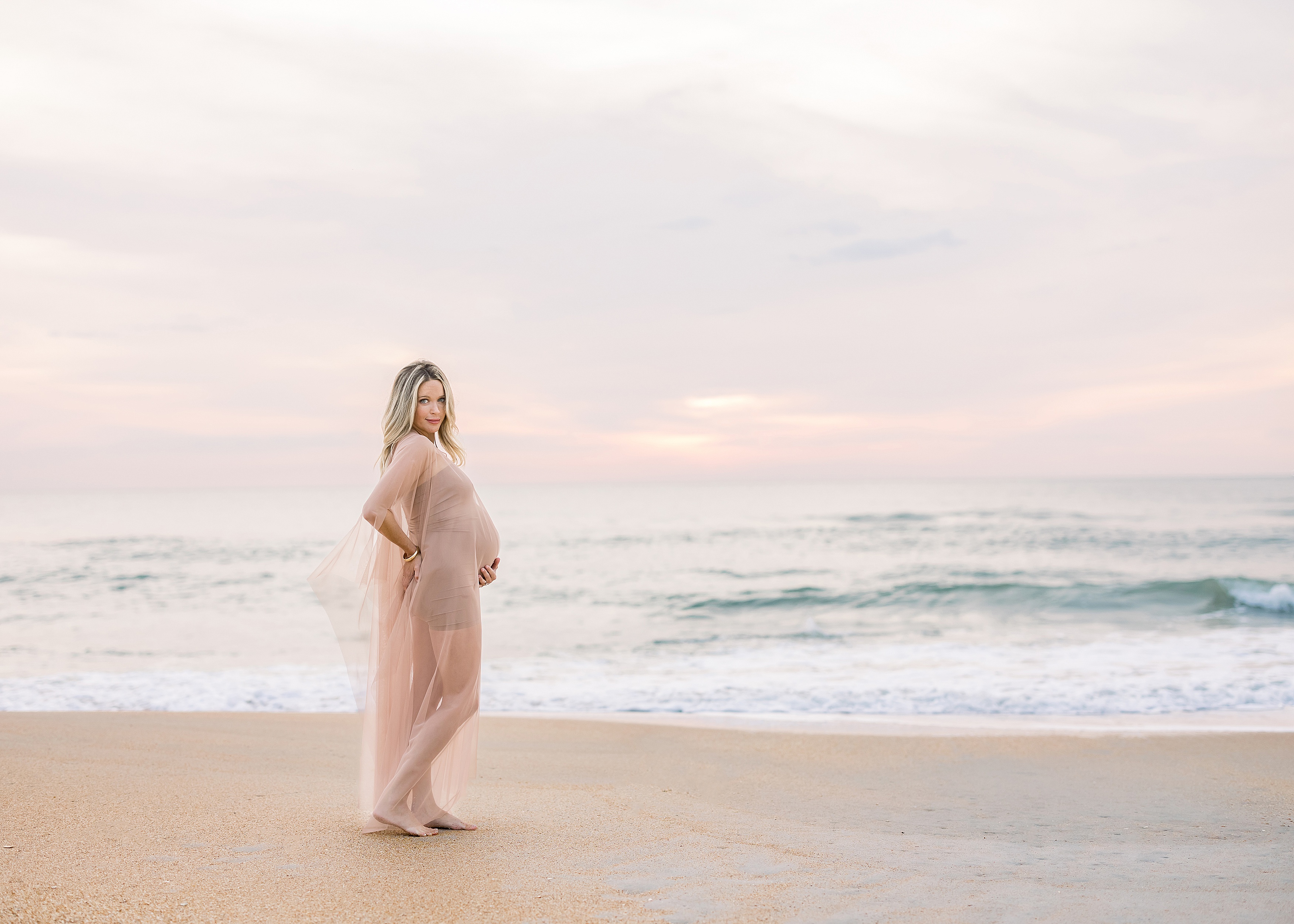 pregnant woman at the beach at sunrise st. augustine florida