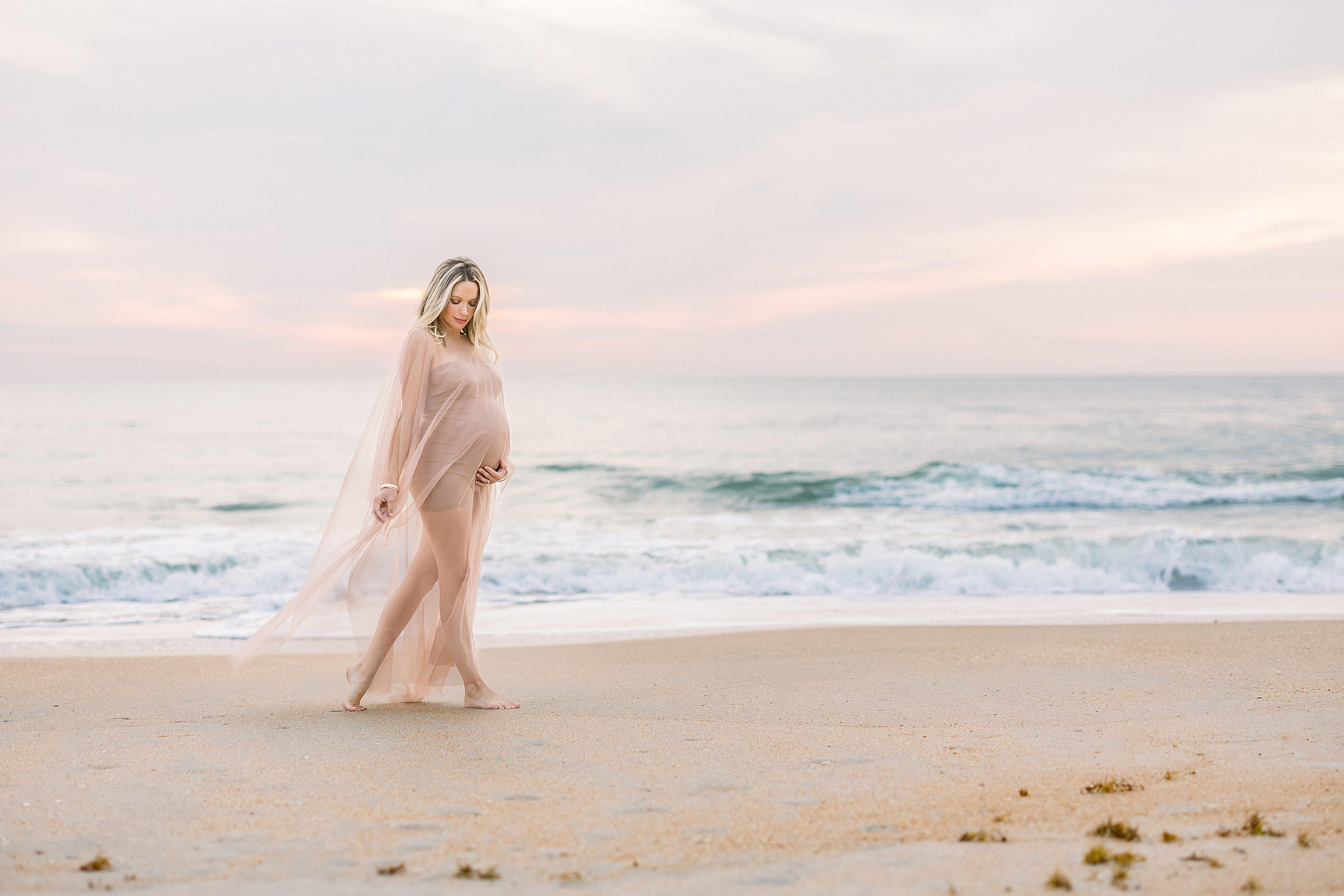 maternity photograph of blond woman in Saint Augustine Beach at sunrise