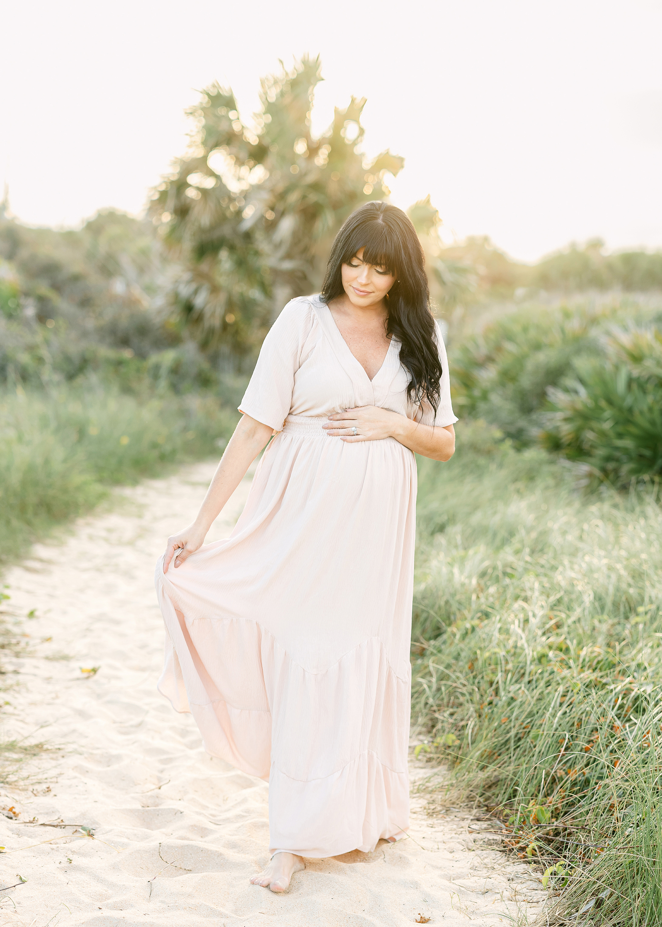 Airy maternity portrait of a woman on the beach in St. Augustine, Florida.