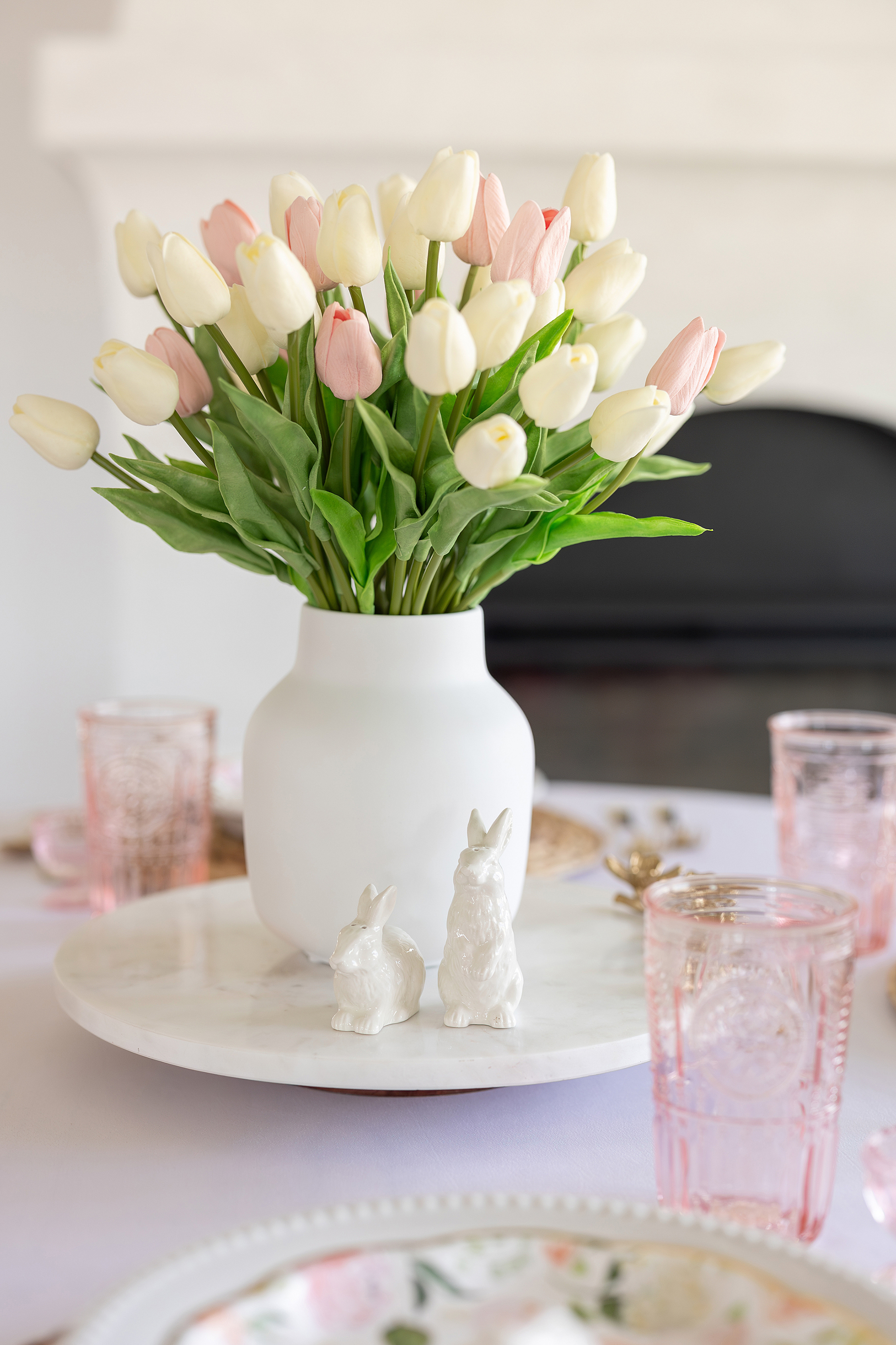 A colorful pastel Easter photo of a table set with pink and whites.