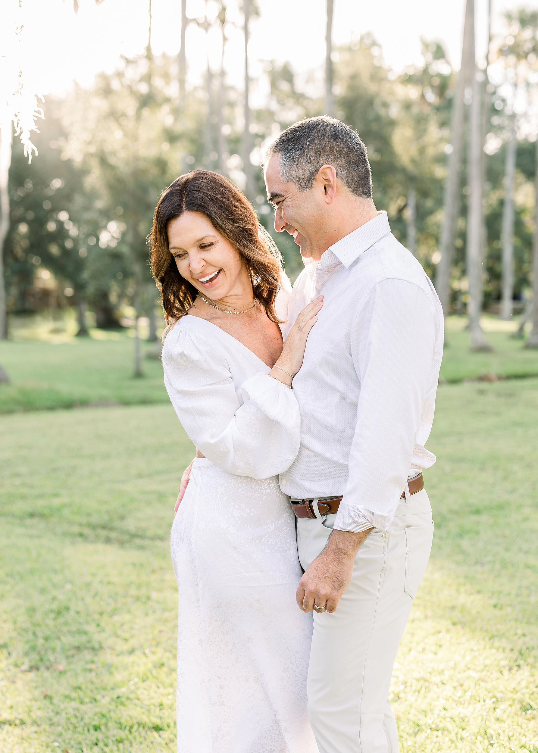 An airy portrait of a couple dressed in white embracing each other in Johansen Park.