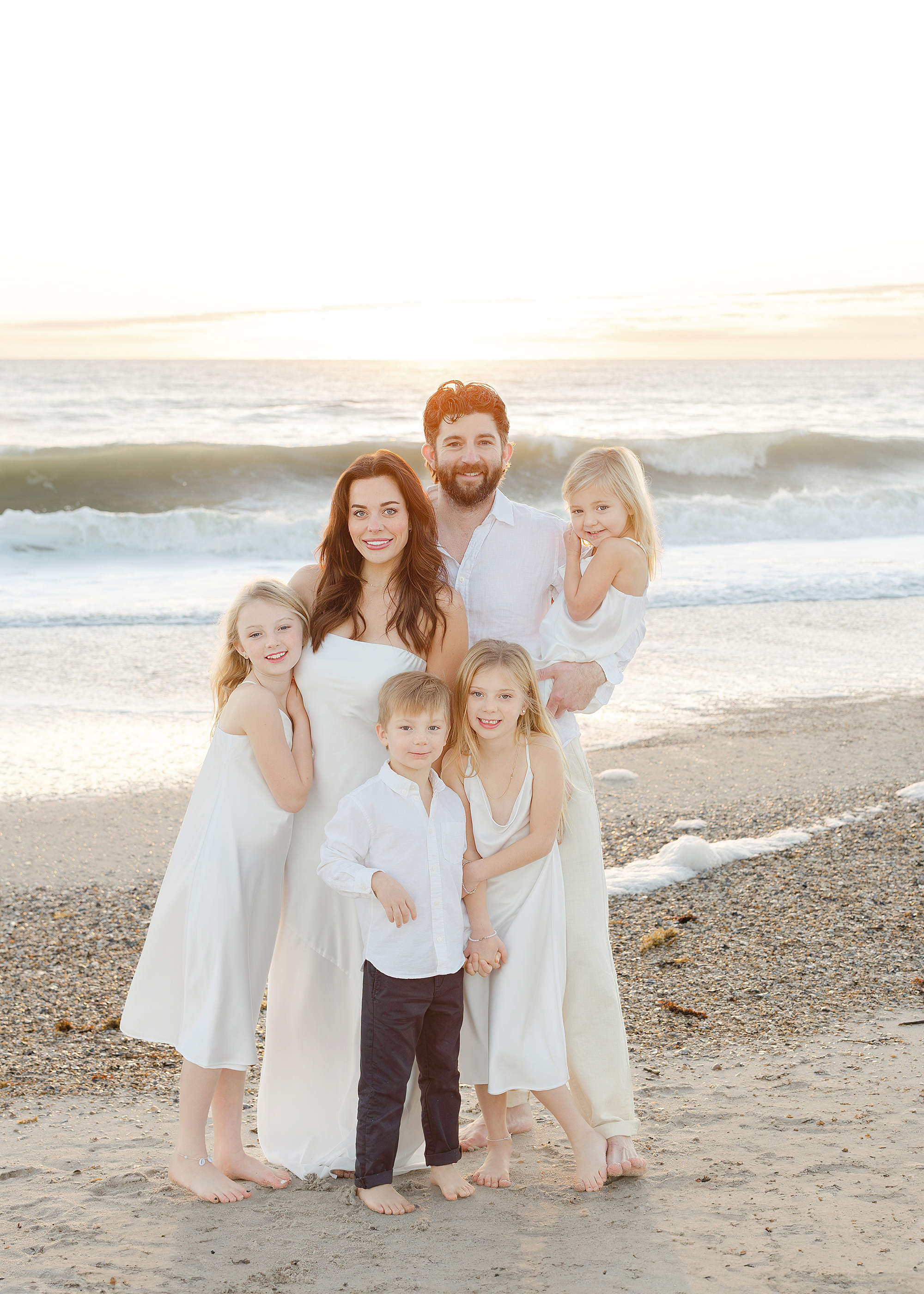 A blended family sunrise beach portrait of a man and woman with their children at the Omni Resort, Amelia Island.