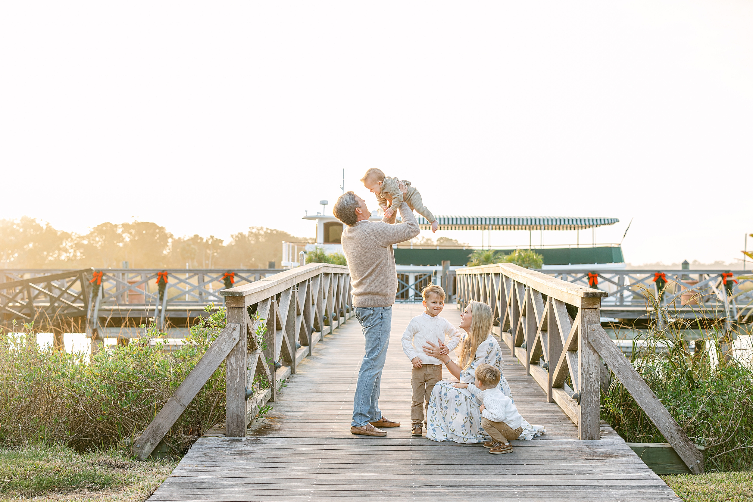 A family of five plays together on the dock of The Cloister in Sea Island, GA.