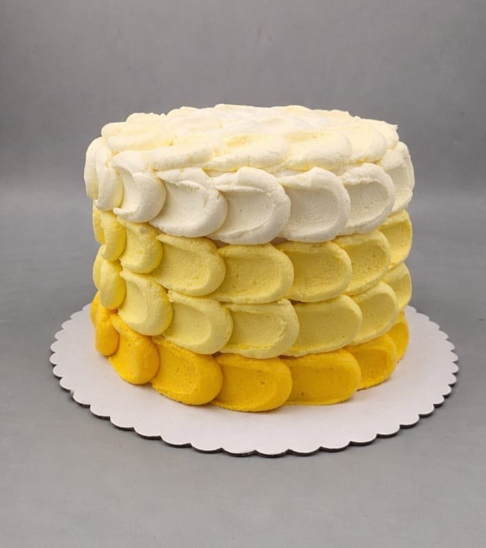 Yellow ombre first birthday cake with petal-style buttercream