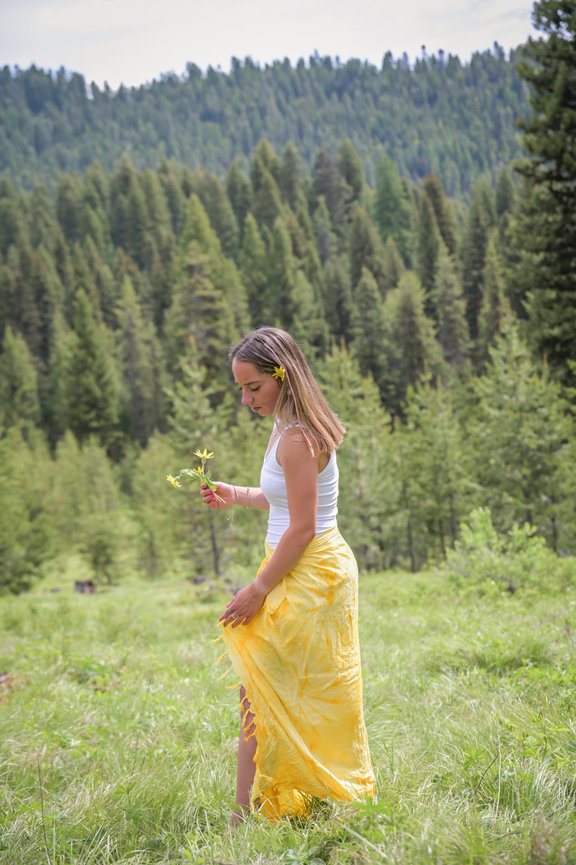 Senior year girl in sundress wondering through a mountain field. McCall, Idaho