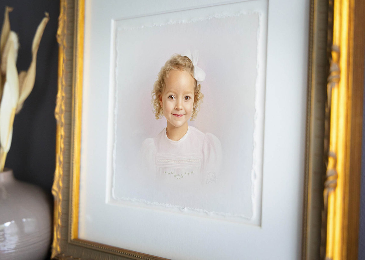 Fine art pastel headshot of a little girl with loose curls and a classic neckline.