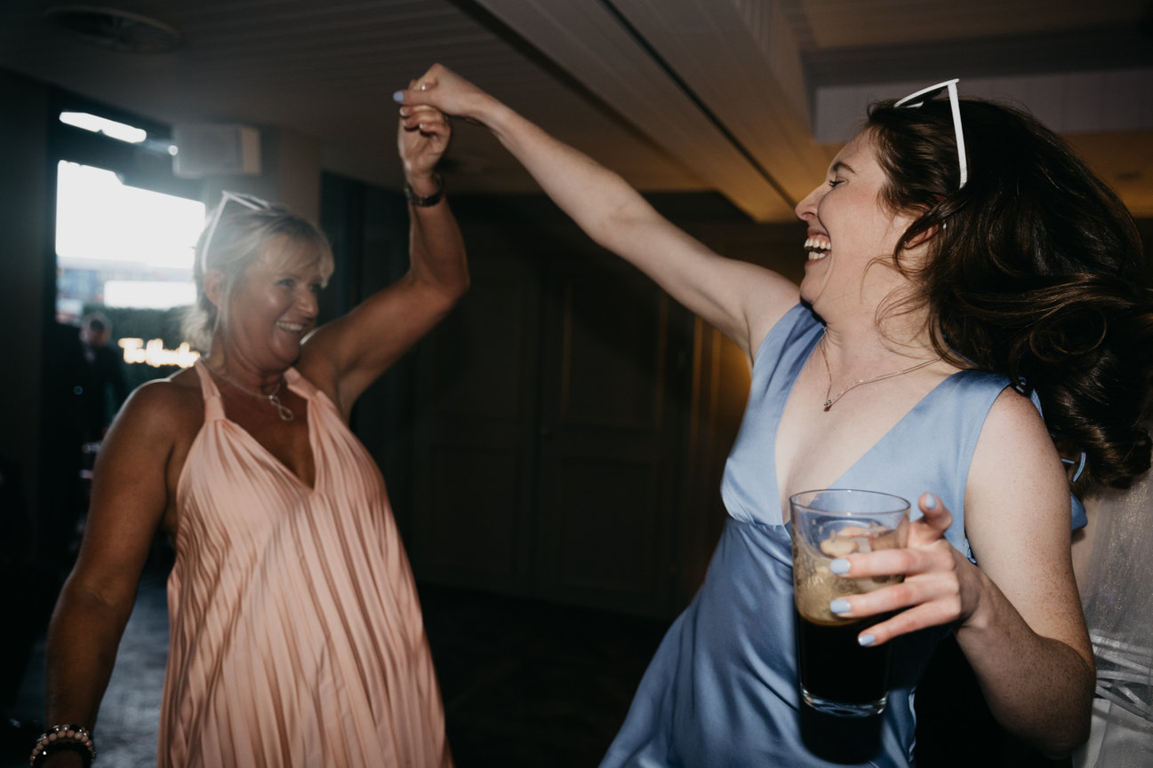 Editorial flash photography at King Street Townhouse; a candid, high-energy shot of wedding guests on the dance floor.