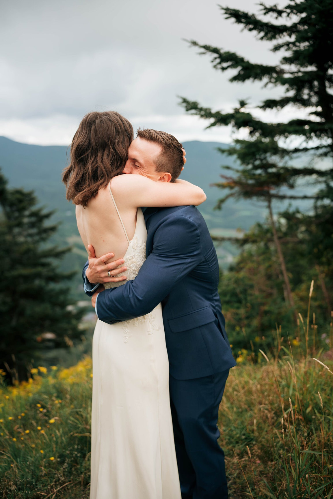 Couple embracing on Mount Mansfield during their Stowe elopement