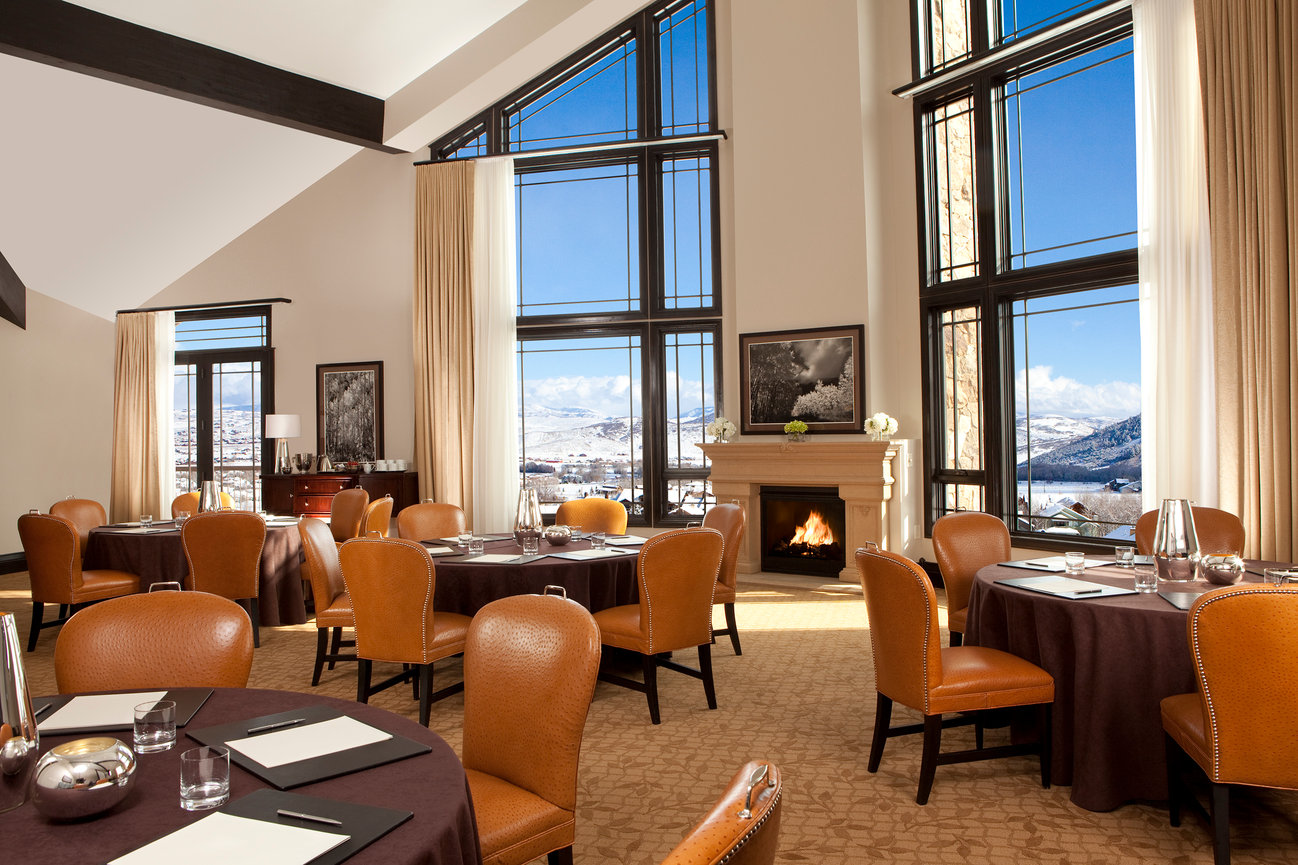 Waldorf Meeting Room set in a larger size room with fireplace by window showing view of the Park City Mountains and ski slopes..