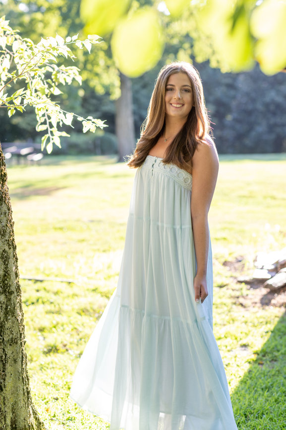 Beautiful young woman being photographed in sunlight