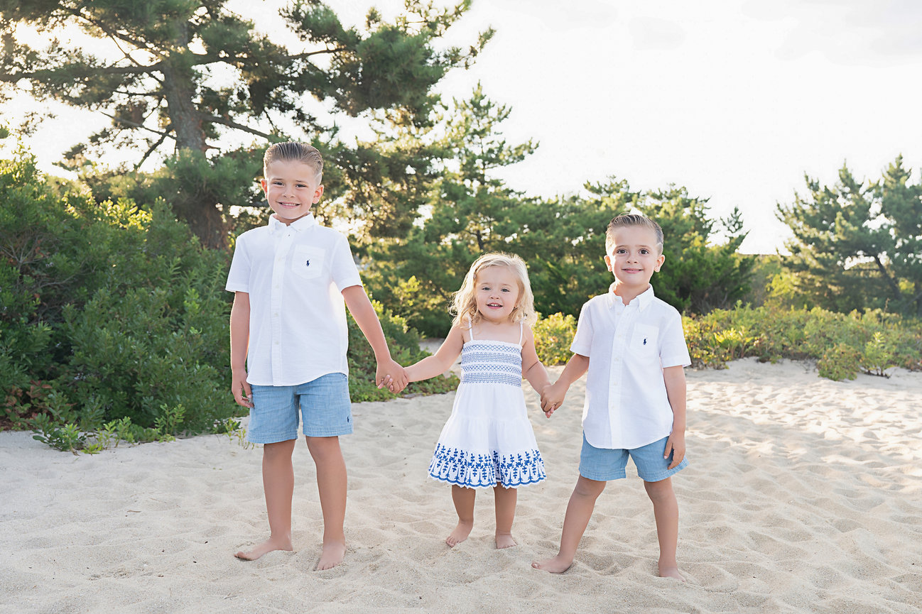 Siblings holding hands walking towards the camera