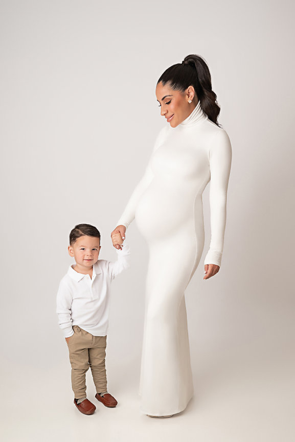 Studio maternity session in Manasquan NJ featuring glowing mother with toddler son in coordinating neutral tones.
